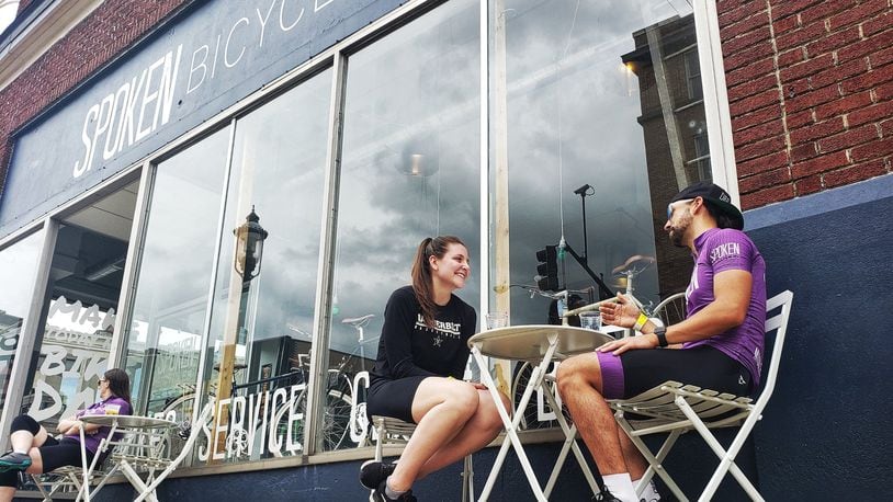 Whitney Wyckoff and Matthew Russell use the outdoor seating at Spoken Bicycles Saturday, May 16. 2020, in Middletown. Outdoor seating for restaurants and bars was reopened Friday after nearly two months of being shut down during the coronavirus pandemic. NICK GRAHAM/STAFF