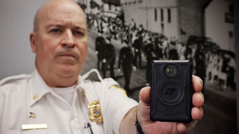 Middletown Acting Police Chief Eric Crank with a body camera that supervisors are slated to begin wearing this spring. NICK GRAHAM/STAFF