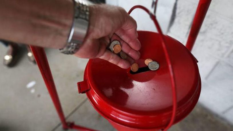 A donation is made into a Salvation Army red kettle on November 28, 2017 in Hallandale, Florida. Giving Tuesday is a single day following the heavy Thanksgiving shopping period specifically focused on charity. (Photo by Joe Raedle/Getty Images)