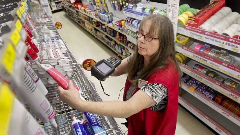 Ace Hardware Paint Department Manager Sharon Griffen uses a hand-held PDA to verify prices at the 1950 E. Stroop Road Kettering Ace store in this 2020 photo.