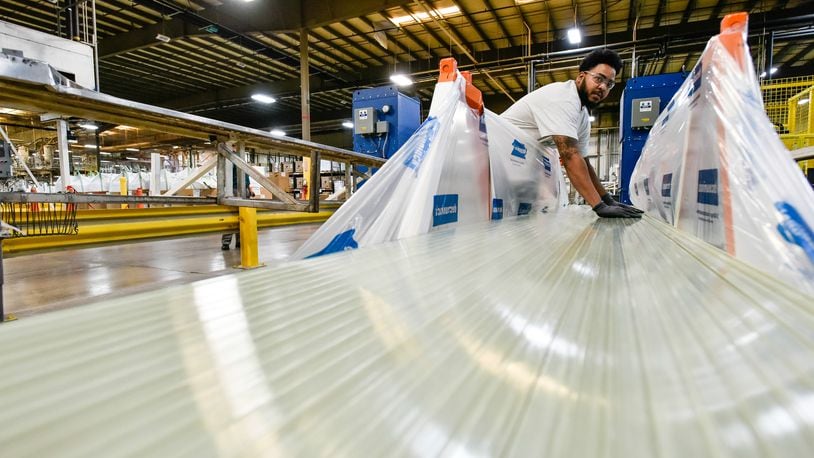 Deceuninck North America announced this week it will temporarily lay off 125 employees at its Monore plant due to the novel coronavirus, COVID-19. Pictured in October 2019 is Tryvale Redmond as he stacks extruded fiberglass products at Deceuninck North America. NICK GRAHAM/FILE