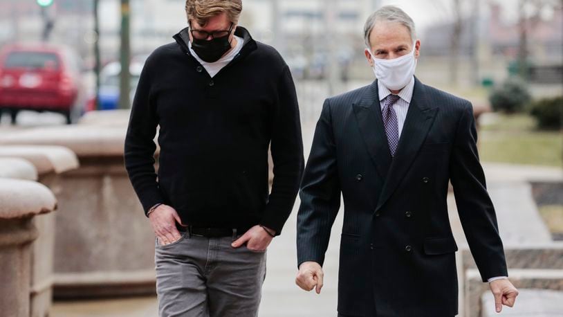 Dustin Thompson, left, of Columbus, who is accused of being part of the Jan. 6 insurrection at the U.S. Capitol, arrives with his lawyer, Sam Shamansky, to turn himself in on Monday, Jan. 25, 2021, at the Joseph P. Kinneary U.S. District Courthouse in Columbus, Ohio. (Joshua A. Bickel/The Columbus Dispatch via AP)