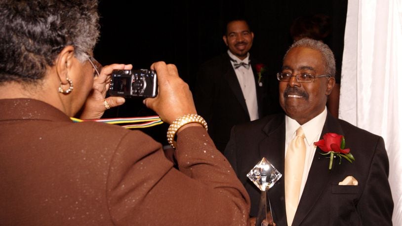 With incoming President of the Dayton Urban League Sheldon Mitchell (center) looking on, Dayton Weekly News reporter Barbara Vinzant (left) takes a picture of Dayton Weekly News CEO and honoree Don Black during the 11th Annual Dayton Urban League Gala at the Dayton Art Institute, Friday, November 7, 2008.