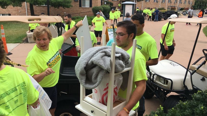 Wright State University faculty senate president Laura Luehrmann helps freshman students move into dorms in August 2019. Making the transition from high school to college can be difficult for some students. STAFF PHOTO / HOLLY SHIVELY