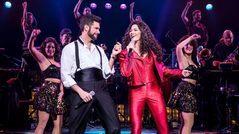 Mauricio Martinez as Emilio Estefan and Christie Prades as Gloria Estefan with the Company in the national tour of “On Your Feet!,” slated March 5-10 at the Schuster Center. CONTRIBUTED/MATTHEW MURPHY