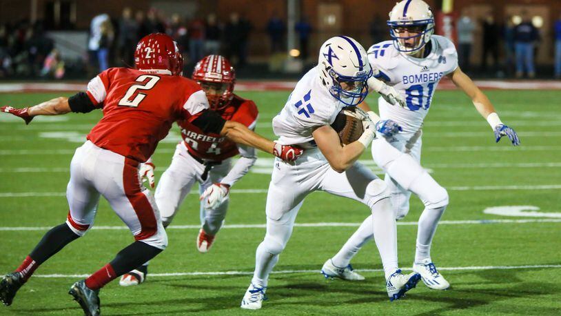 Fairfield’s Kyle Schimpf (2) goes after St. Xavier wide receiver Andrew Wittrock (12) during their Division I playoff game at Fairfield Stadium on Nov. 4, 2016. The visiting Bombers won 35-14. GREG LYNCH/STAFF