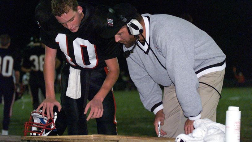 Matt Hopkins is Preble Shawnee’s head football coach, but he used to play quarterback for the Arrows. He is shown receiving instructions from PS coach Rick Newsock during a game against Dixie on Oct. 30, 1998. COX MEDIA FILE PHOTO