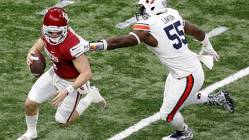 NEW ORLEANS, LA - JANUARY 02: Baker Mayfield #6 of the Oklahoma Sooners avoids a tackle by Carl Lawson #55 of the Auburn Tigers during the Allstate Sugar Bowl at the Mercedes-Benz Superdome on January 2, 2017 in New Orleans, Louisiana. (Photo by Jonathan Bachman/Getty Images)