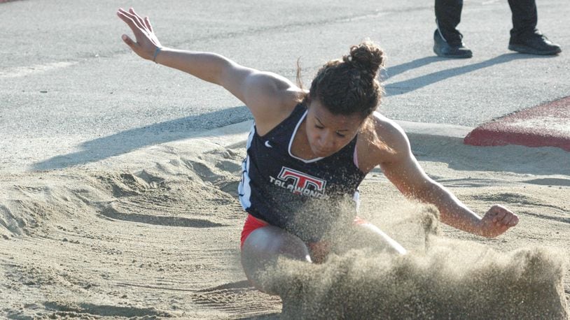 Talawanda’s Kyra Koontz lands in the long-jump pit Tuesday during the ninth annual Dale Plank Invitational track & field meet at Talawanda. Koontz won four individual events, helping the host Brave win the girls team championship. RICK CASSANO/STAFF