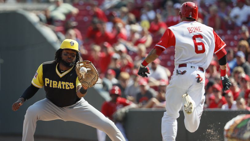 Pittsburgh Pirates first baseman Josh Bell, left, puts out Cincinnati Reds' Billy Hamilton at first in the seventh inning of a baseball game, Sunday, Aug. 27, 2017, in Cincinnati. (AP Photo/John Minchillo)