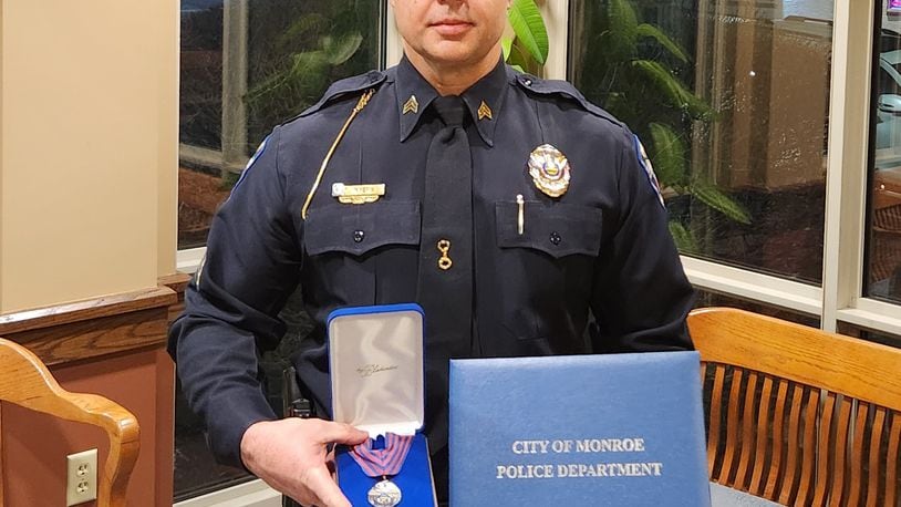 Sgt. Eddie Myers from the Monroe Police Department was presented the Distinguished Service Medal with Valor Tuesday night for his efforts trying to save a woman's life after she drove into a retention pond off I-75 on Oct. 29, 2023. SUBMITTED PHOTO