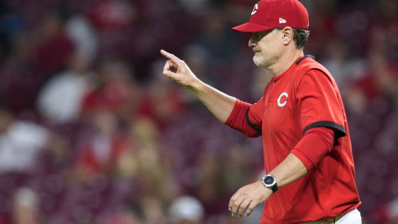 Cincinnati Reds manager David Bell signals to the bullpen during the seventh inning of the team's baseball game against the St. Louis Cardinals on Wednesday, Aug. 31, 2022, in Cincinnati. (AP Photo/Jeff Dean)