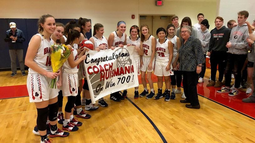 Talawanda coach Mary Jo Huismann celebrates with her players after winning her 700th game Saturday. Mark Schmetzer/CONTRIBUTED