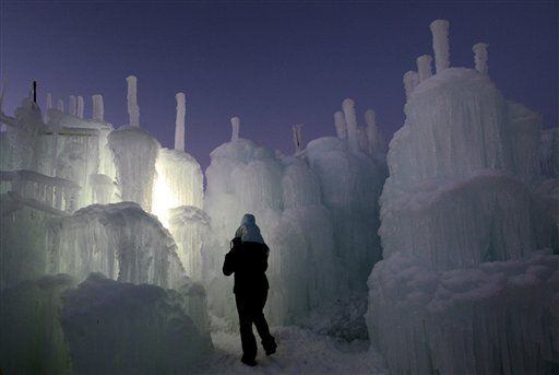 A man and his child walk through the 20-foot high Ice Castle at the Mall of America in Bloomington, Minn. on Monday, Dec. 31, 2012.