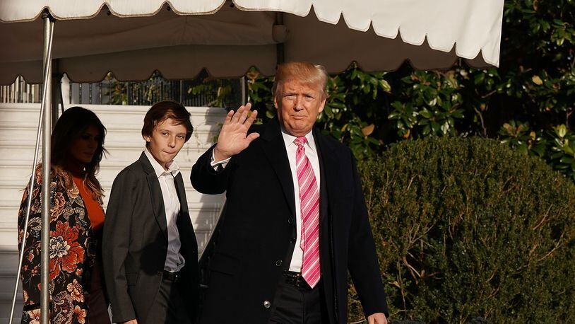 President Donald Trump waves to journalists as he leaves the White House with his family as they head to Mar-a-Lago in Florida for the Thanksgiving holiday.