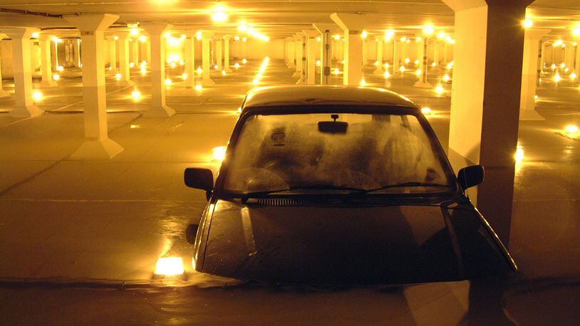 At least a dozen cars were partially submerged underwater Wednesday morning at Dallas Love Field Airport after heavy storms hit the area overnight.