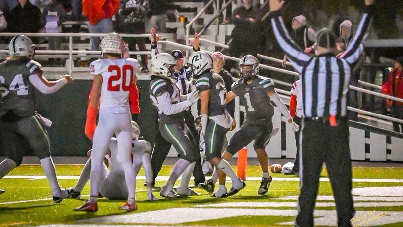 Badin's Carson Cheek (23) celebrates his game-winning touchdown with teammates on Friday night. The Rams beat Wapakoneta 14-10 to advance to the Division III regional finals. Betsey Miyahara/CONTRIBUTED