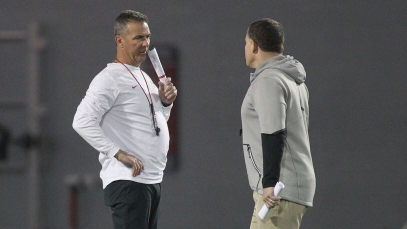 Ohio State’s Urban Meyer talks to Greg Schiano during practice on Monday, March 26, 2018, at the Woody Hayes Athletic Center in Columbus. David Jablonski/Staff