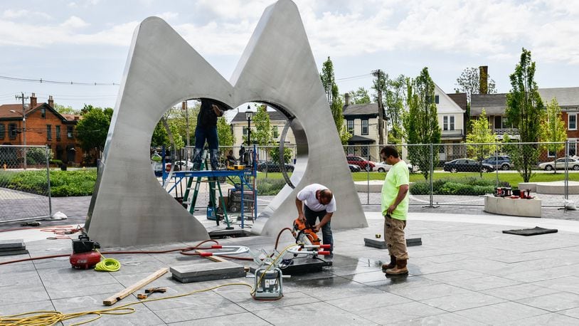 Workers were installing a new sculpture in Hamilton’s Marcum Park this past week. The fountain should begin flowing May 12 during the Hamilton Flea event. NICK GRAHAM/STAFF