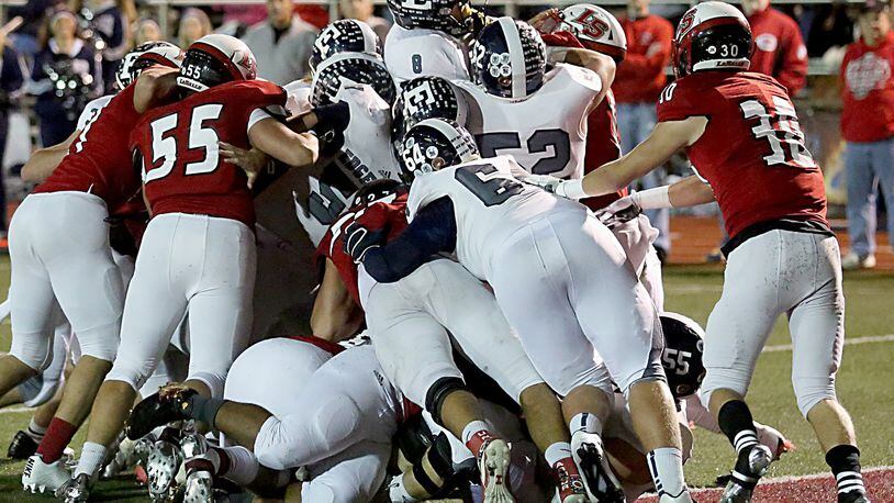 Edgewood quarterback Drew Reckart (8) rides the scrum into the end zone for a touchdown against La Salle during their Division II, Region 8 playoff game at Lancer Stadium in Cincinnati on Friday night. CONTRIBUTED PHOTO BY E.L. HUBBARD