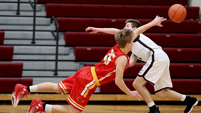 Fenwick forward Luke Bradshaw gets off a pass as Lebanon guard Sammy Stotts pressures during their game at Lebanon on Dec. 17, 2016. COX MEDIA FILE PHOTO