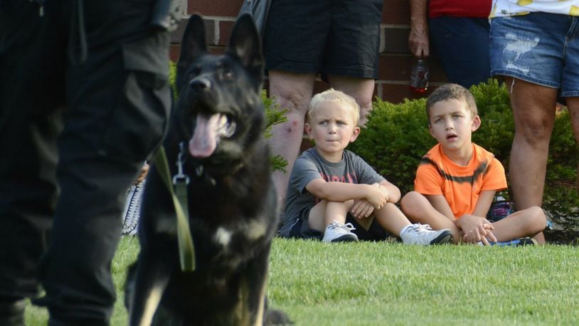 2017 FILE PHOTO: Fairfield hosts its first National Night Out in about 15 years on Tuesday, Aug. 1, 2017, at the Justice Center on Pleasant Avenue. A couple of kids watch as K9 Officer Scout demonstrates his ability to listen to commands from his partner and handler Fairfield police Officer Sam Larsh. MICHAEL D. PITMAN/FILE