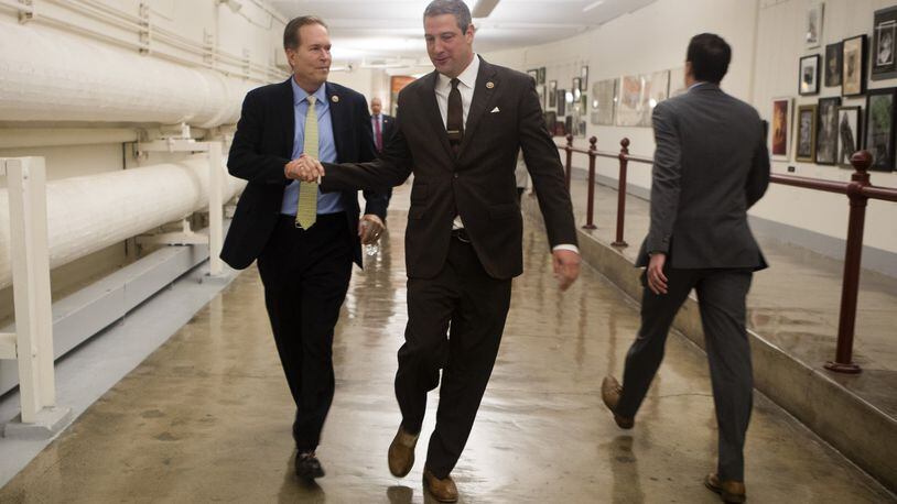 Reps. Tim Ryan, D-Ohio, right, and Vern Buchanan, R-Fla., head to a news conference on Capitol Hill in Washington, Nov. 17, 2016. Ryan is challenging House Minority Leader Nancy Pelosi, D-Calif., for her position in upcoming party elections. (Stephen Crowley/The New York Times)