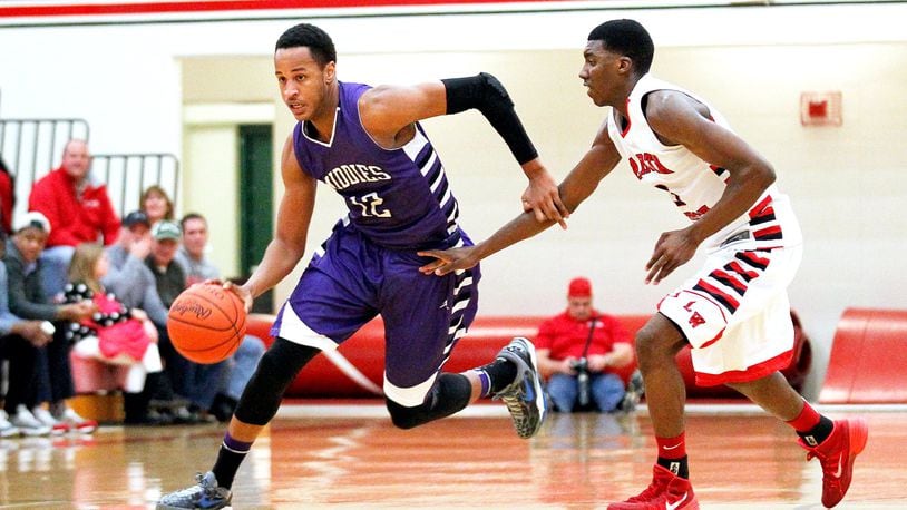 Middletown’s Vincent Edwards (12) dribbles the ball around Lakota West’s Latrell Tidwell (3) during a game at West on Jan. 10, 2014. JOURNAL-NEWS FILE PHOTO