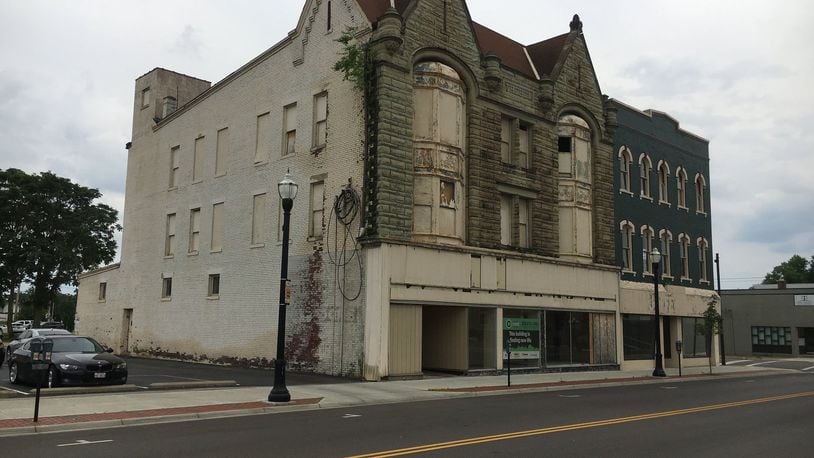 A Hamilton board voted Tuesday to allow demolition of the Treble Building, formerly the Third Street Department Store, at 216 S. Third Street (with the pointed roofline). But in a compromise, the CORE Fund, which owns it, agreed to mark the backs of facade stones and store them so they can be reassembled someday at either the same location or elsewhere. An attached building immediately to the south at 220 S. Third St., known as the Joffe Furniture building, is to be saved. MIKE RUTLEDGE/STAFF
