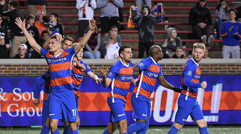 FC Cincinnati forward Danni Konig (11) raised his arms as he is congratulated by teammates after scoring against Pittsburgh Riverhounds in the second half at Nippert stadium. FC Cincinnati battled to a 2 all tie game against the Pittsburgh Riverhounds. Photo by Joseph Fuqua II for WCPO