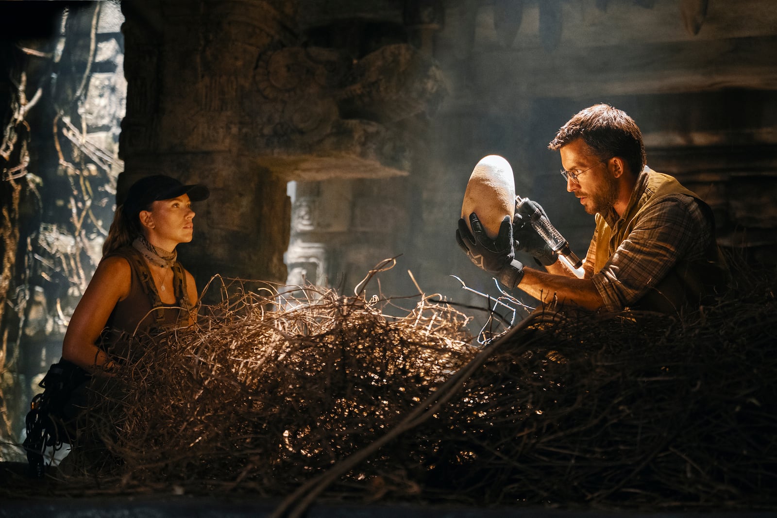 This image released by Universal Pictures and Amblin Entertainment shows Scarlett Johansson, left, and Jonathan Bailey in a scene from " Jurassic World Rebirth." (Jasin Boland/Universal Pictures and Amblin Entertainment via AP)
