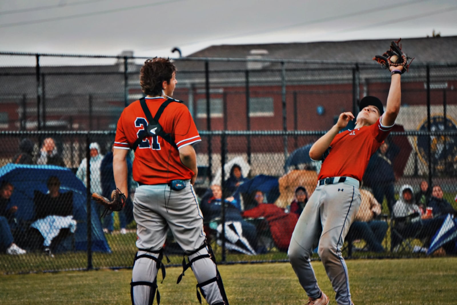Talawanda's Austin Puckett catches a ball while teammate Hunter Griffin watches during their Division III tournament game on Wednesday. CHRIS VOGT / CONTRIBUTED
