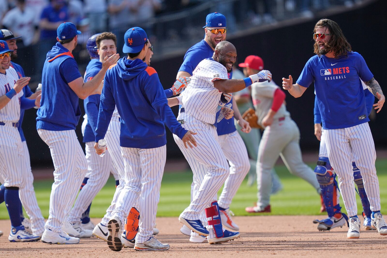 New York Mets' Starling Marte, center, celebrates with teammates after hitting a walk-off single during the tenth inning of a baseball game against the Philadelphia Phillies, Wednesday, April 23, 2025, in New York. (AP Photo/Seth Wenig)