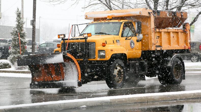 A Hamilton salt truck travels down High Street, Tuesday, Dec. 13, 2016. GREG LYNCH / STAFF