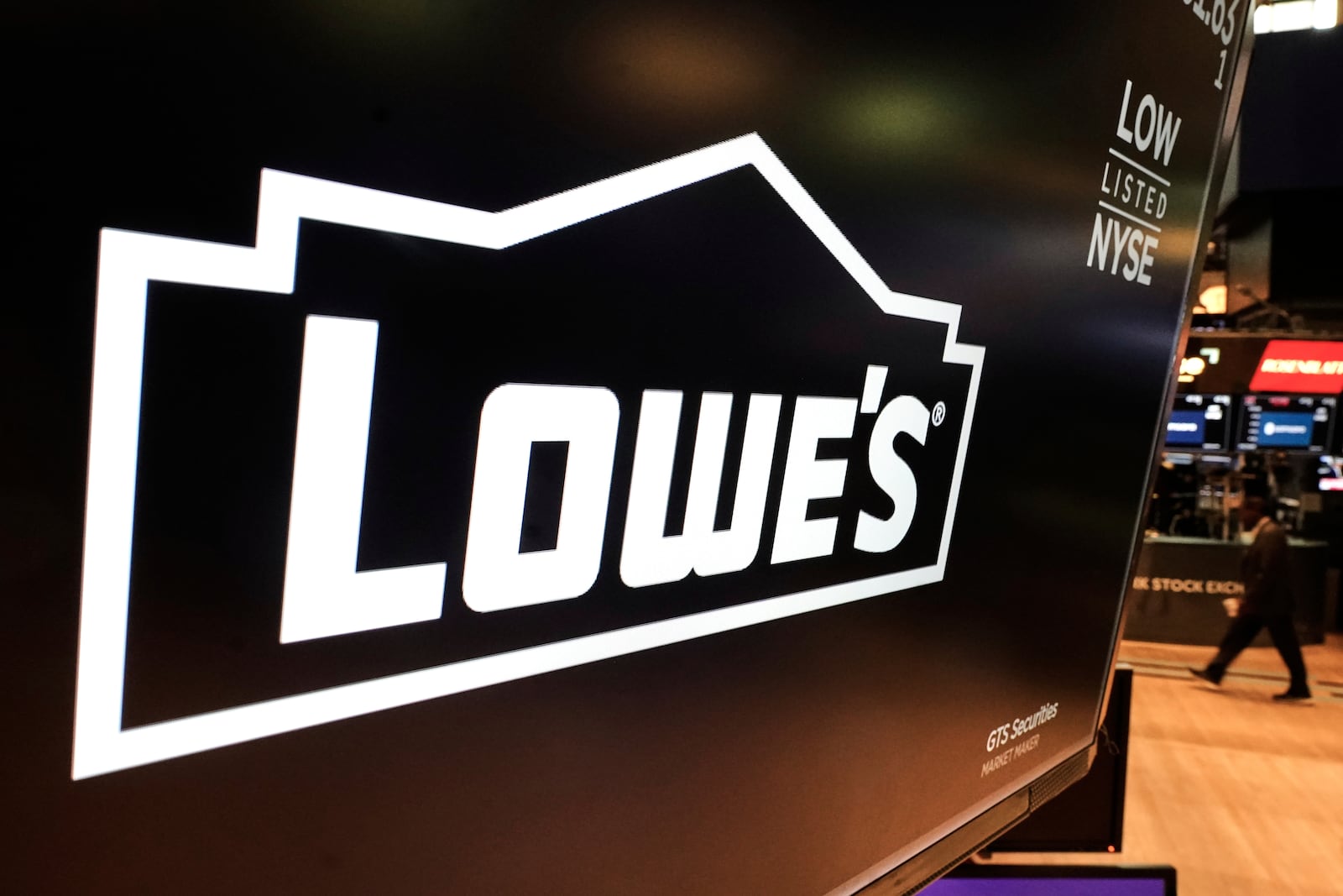 The logo for Lowe's is displayed above a trading post on the floor of the New York Stock Exchange, Tuesday, May 20, 2025. (AP Photo/Richard Drew)