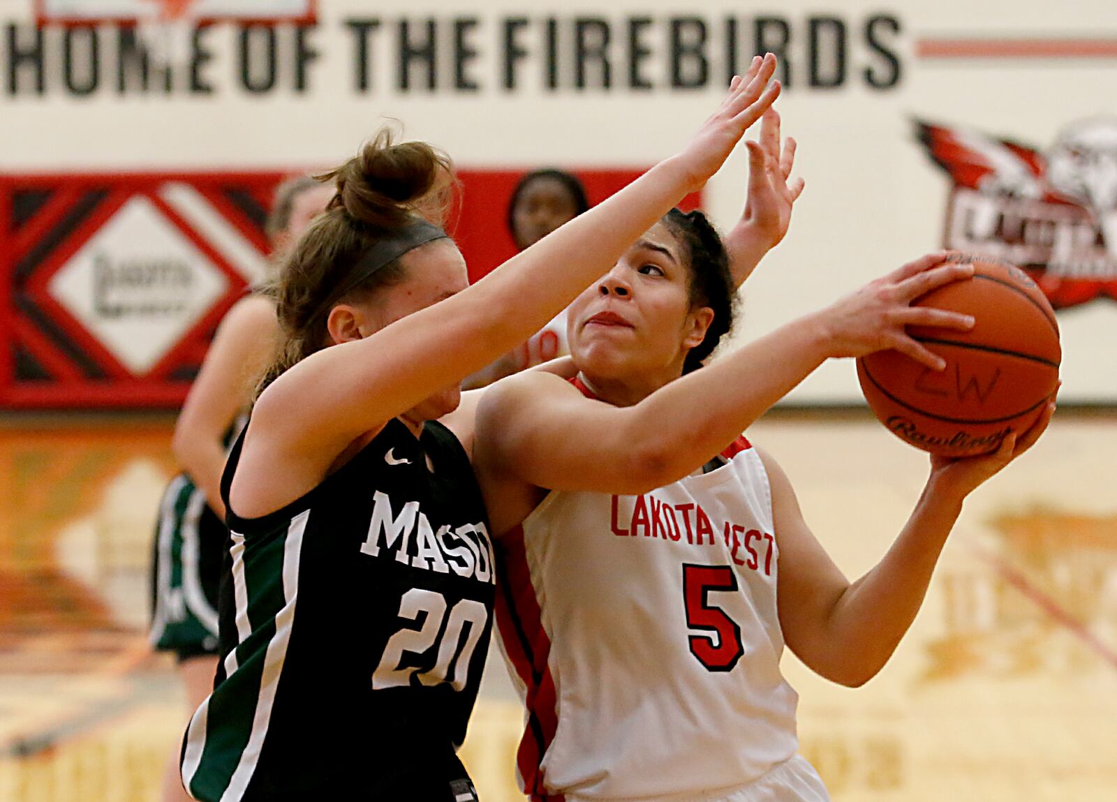 Lakota West guard Amara Flores is covered by Mason guard C.C. Cary during a Greater Miami Conference basketball game in West Chester Jan. 23, 2021. Contributed photo by E.L. Hubbard