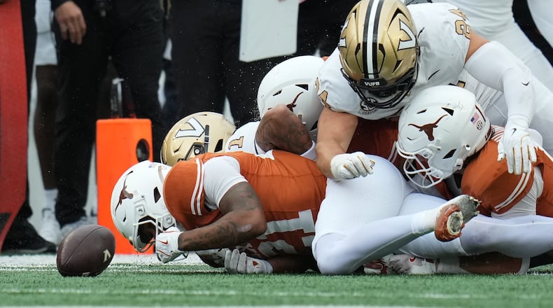Texas wide receiver Ryan Niblett (21) dives ahead of Vanderbilt players for an onside kick during the second half of an NCAA college football game in Austin, Texas, Saturday, Nov. 1, 2025. (AP Photo/Eric Gay)