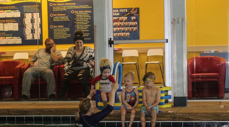 Parker, Garrett and Charlotte receive swim lesson from … at the Aqua-Tots Swim School in Beavercreek. The business reopened at the beginning of October after closing for repairs following the Memorial Day tornado. RICHARD WILSON/STAFF Swaney, Cary Barnhart