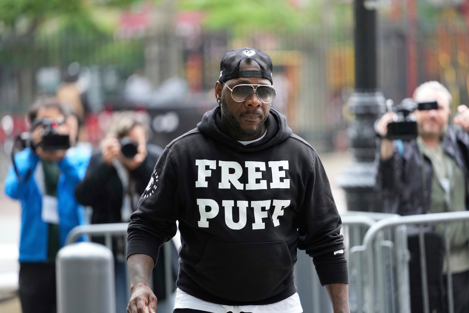 A man arrives to the federal courthouse wearing a shirt supporting Sean "Diddy" Combs in New York, Monday, May 5, 2025. (AP Photo/Seth Wenig)