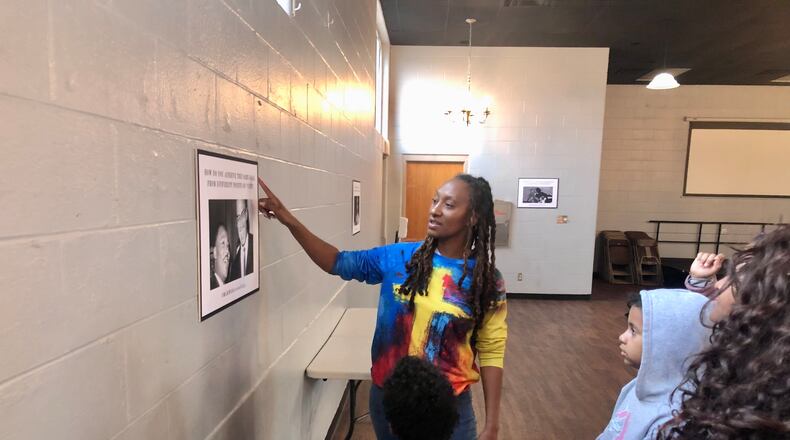 Marie Edwards, director of the Out of School Program at Community Building Institute in Middletown, talks to some students about Martin Luther King Jr.'s message as part of the Middletown Freedom Tour at the Robert "Sonny" Hill Jr. Community Center. RICK McCRABB/STAFF