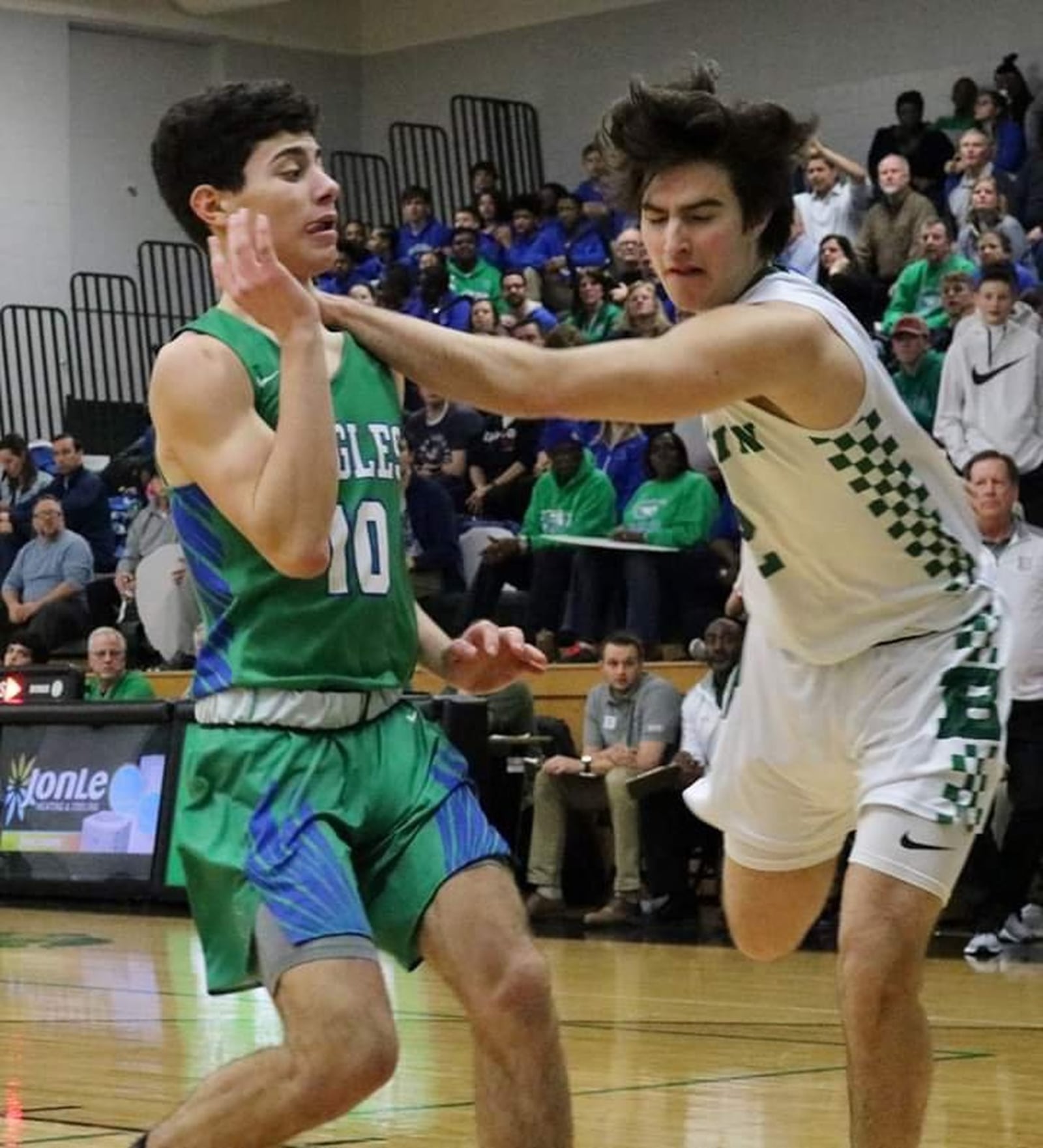 Badin’s Seth Hargis (2) makes contact with Chaminade Julienne’s Jack Nauseef (10) during Friday night’s game at Mulcahey Gym in Hamilton. CJ won 58-54. CONTRIBUTED PHOTO BY TERRI ADAMS