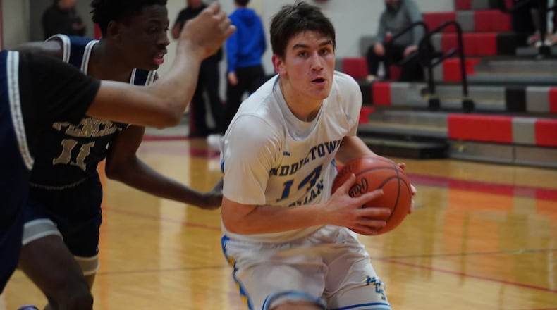Middletown Christian's Caleb Skaggs (14) drives to the basket against Spencer Center on Monday night at Milford. Chris Vogt/CONTRIBUTED