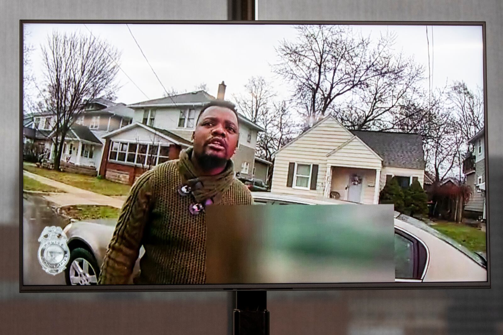 FILE - A TV display shows Patrick Lyoya as video evidence of a Grand Rapids police officer struggling with and shooting Patrick Lyoya is shown at Grand Rapids City Hall in Grand Rapids, Mich., Wednesday, April 13, 2022. (Grand Rapids Police Department via AP)