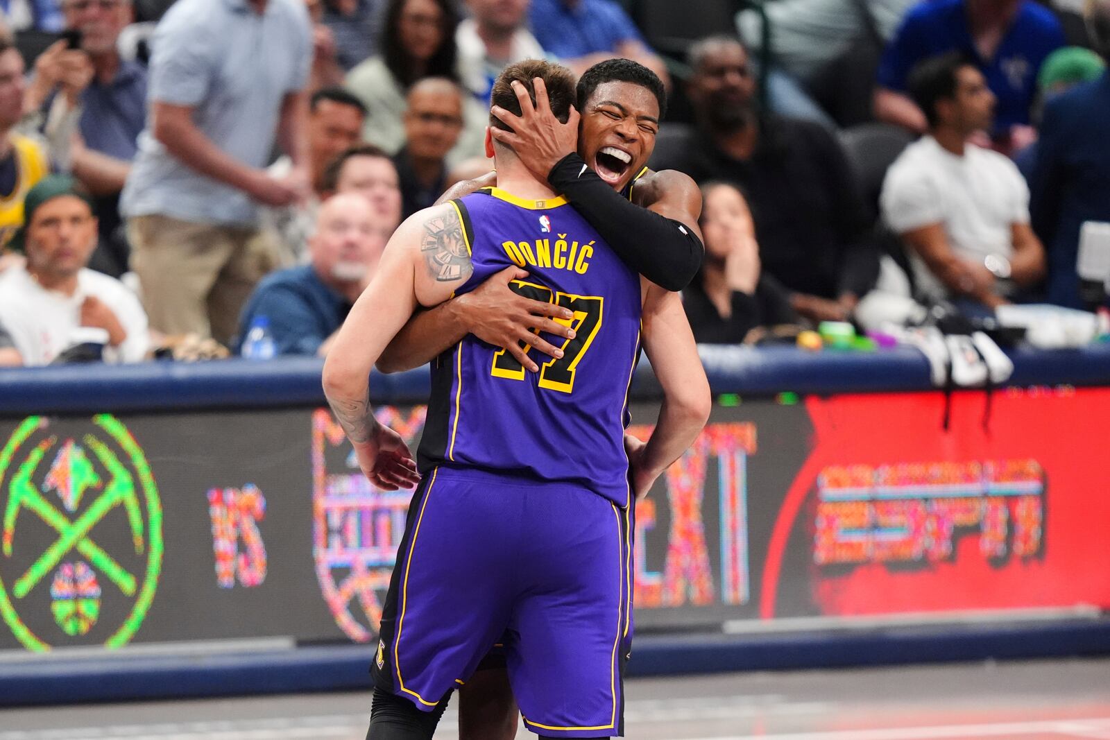 Los Angeles Lakers' Luka Doncic (77) and Rui Hachimura, center right, celebrate late in the second half of an NBA basketball game against the Dallas Mavericks in Dallas, Wednesday, April 9, 2025. (AP Photo/LM Otero)