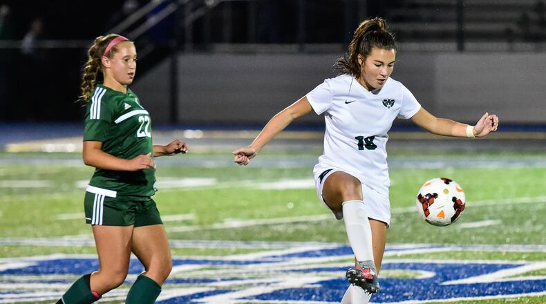 Badin’s Jamie Lehker controls the ball while being defended by Allison Vaughn from McNicholas during their Division II sectional final Oct. 23 at Winton Woods. Badin won 2-1. NICK GRAHAM/STAFF