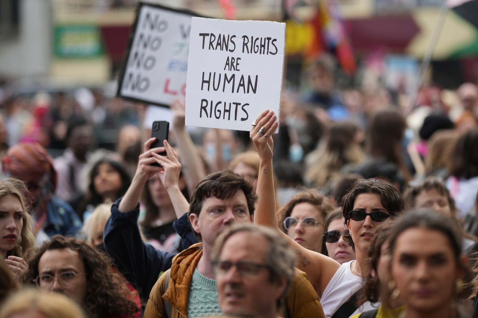 Campaigners take part in a rally organised by trans rights groups, trade unions, and community organisations following the Supreme Court ruling on the definition of a woman in equalities law, at Parliament Square, central London, Saturday April 19, 2025. (AP Photo/Alastair Grant)