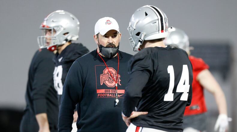 Ohio State coach Ryan Day, left, talks with quarterback Kyle McCord during an NCAA college football practice in Columbus, Ohio, Monday, April 5, 2021. (AP Photo/Paul Vernon)