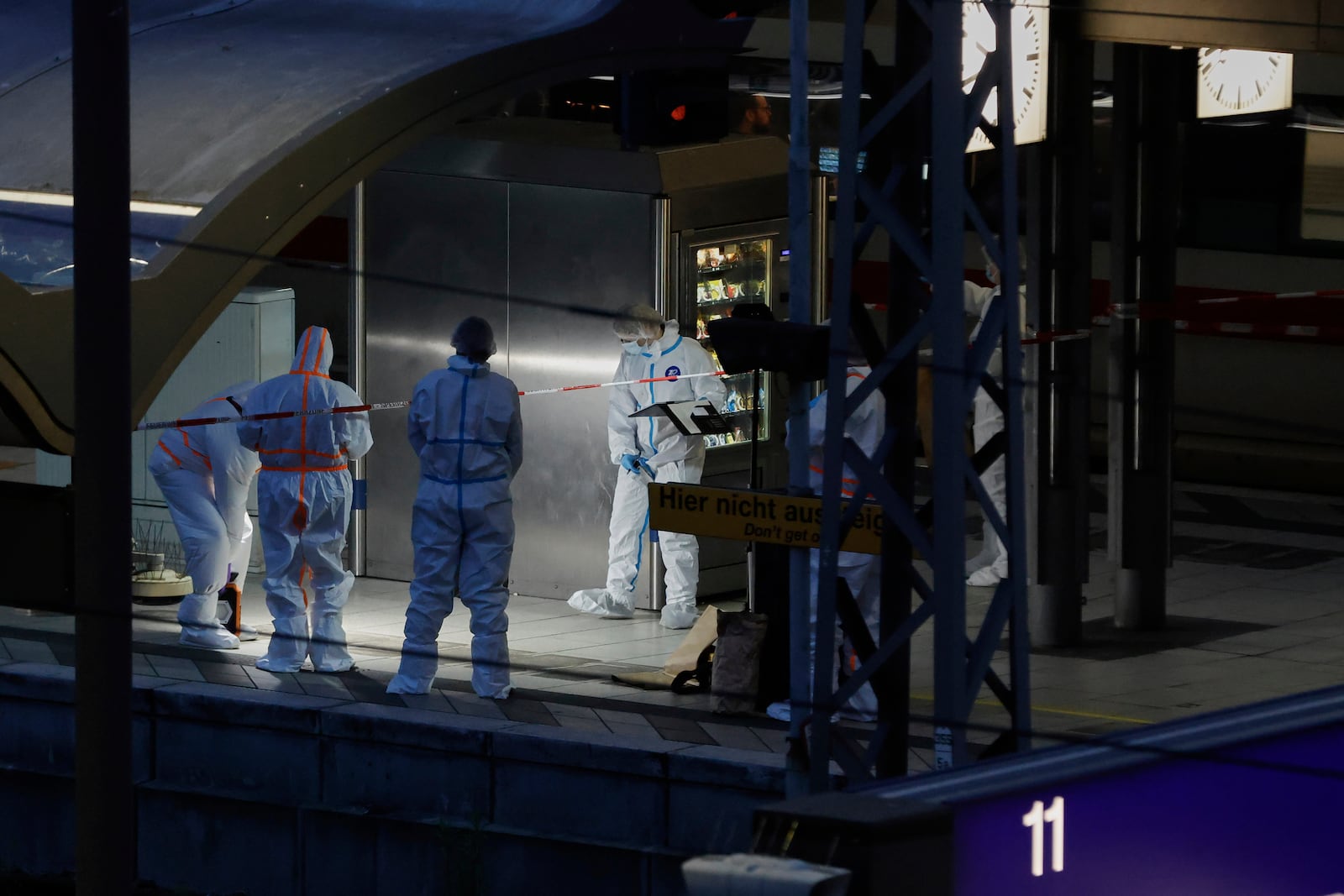 Investigators work at Hamburg, Germany's Central Station on Friday, May 23, 2025, after several people were injured in a knife attack. (Georg Wendt/dpa via AP)