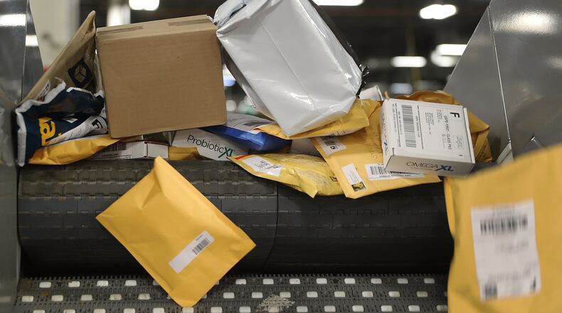 Packages advance on a conveyor belt as they are sorted at the U.S. Postal service’s Royal Palm Processing and Distribution Center on December 4, 2017 in Opa Locka, Florida. (Photo by Joe Raedle/Getty Images)