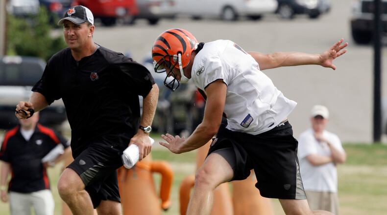 Cincinnati Bengals kicker Dave Rayner runs downfield with special teams coach Darrin Simmons, left, after Rayner kicked off during practice Thursday, Aug. 5, 2010, at the NFL football team's training camp in Georgetown, Ky. (AP Photo/Al Behrman)